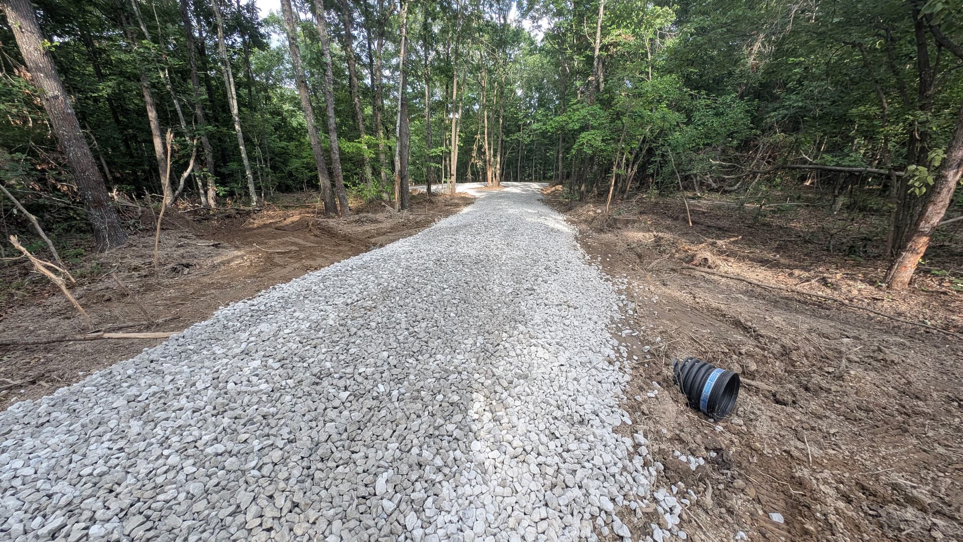 Gallery photos for Gravel Driveway Cut Through the Woods for Clean Property Access: Image #1